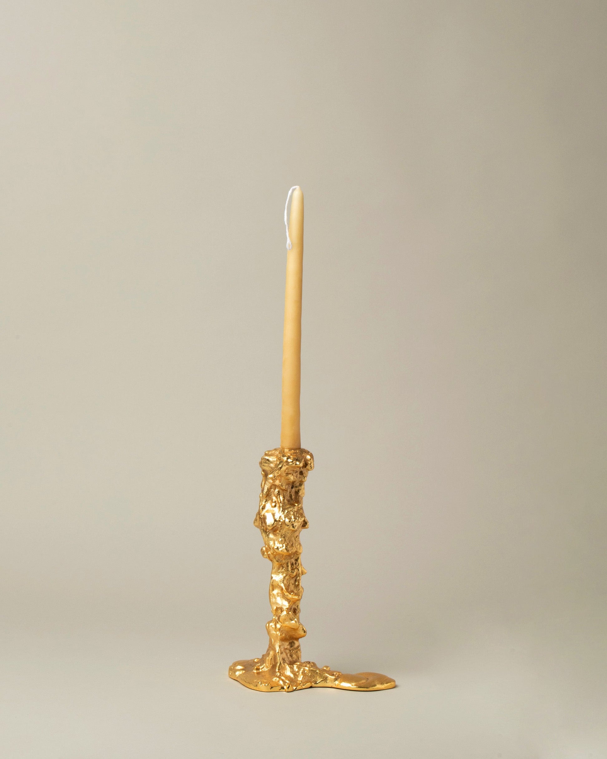 POLSPOTTEN Gold Medium Drip Candle Holder on light color background.