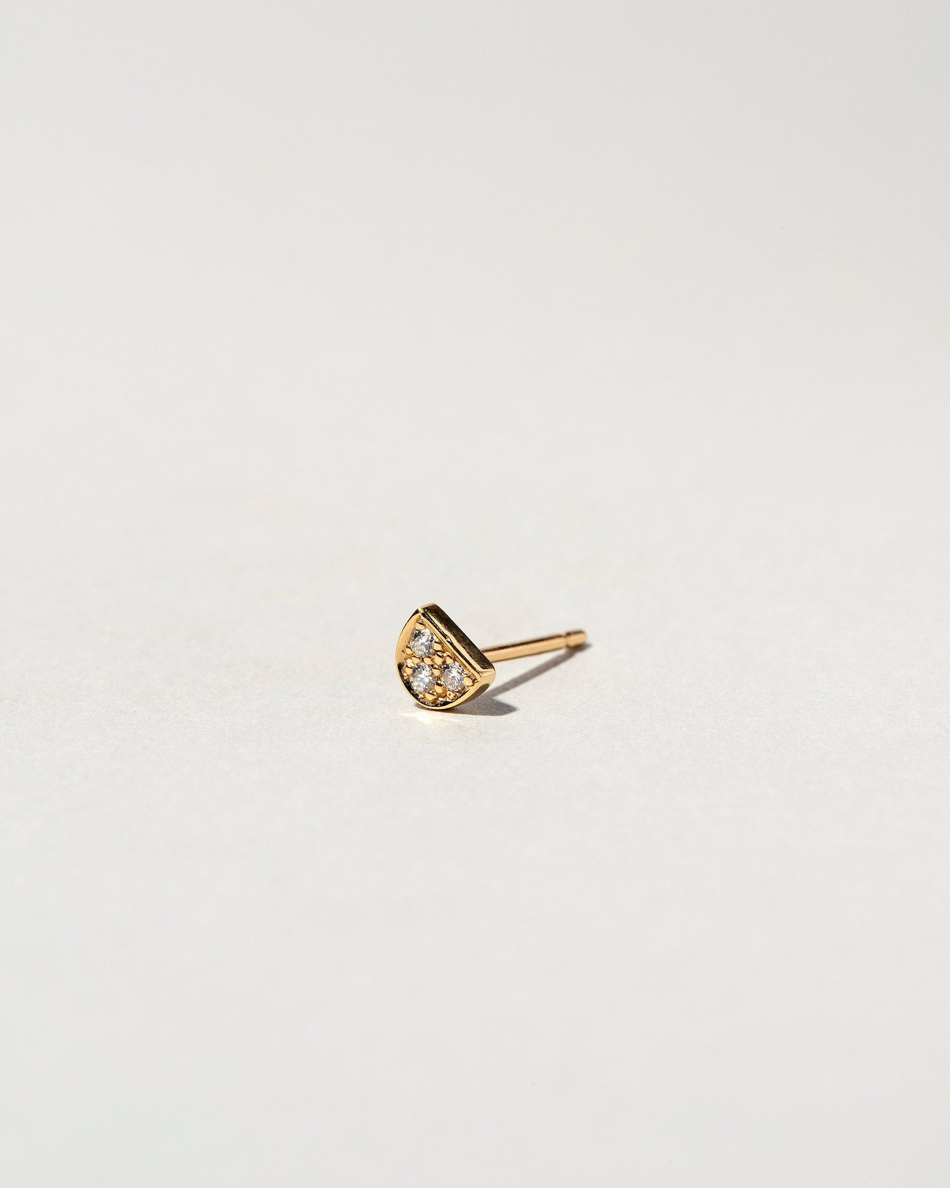 White Diamond Half Moon Stud Earring Single on light color background.