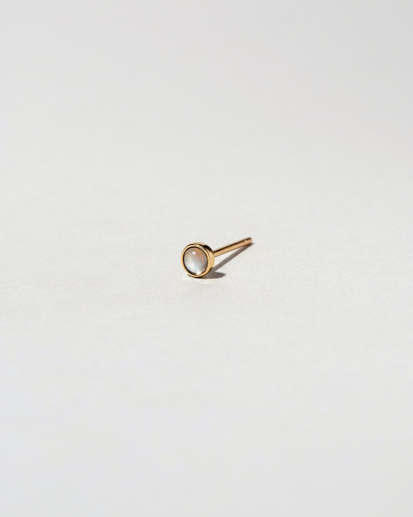 Birthstone Single Stud on light color background.