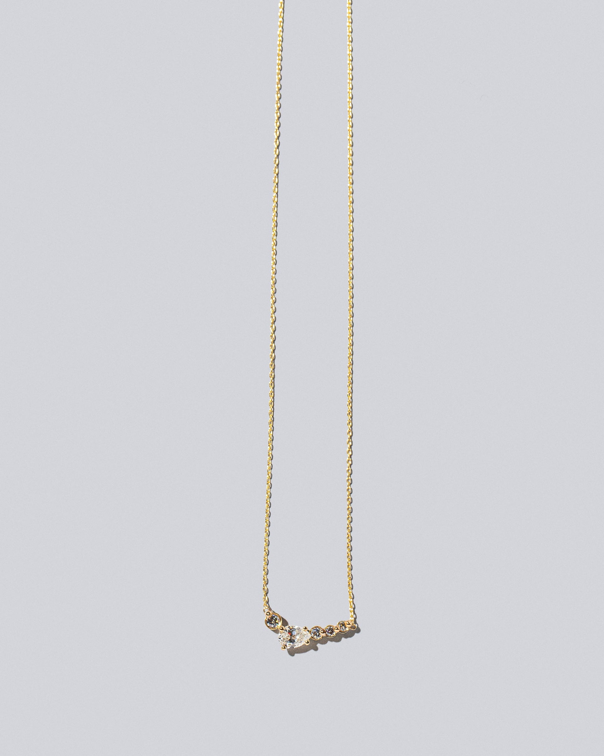Teardrop Necklace - Diamonds on light color background.