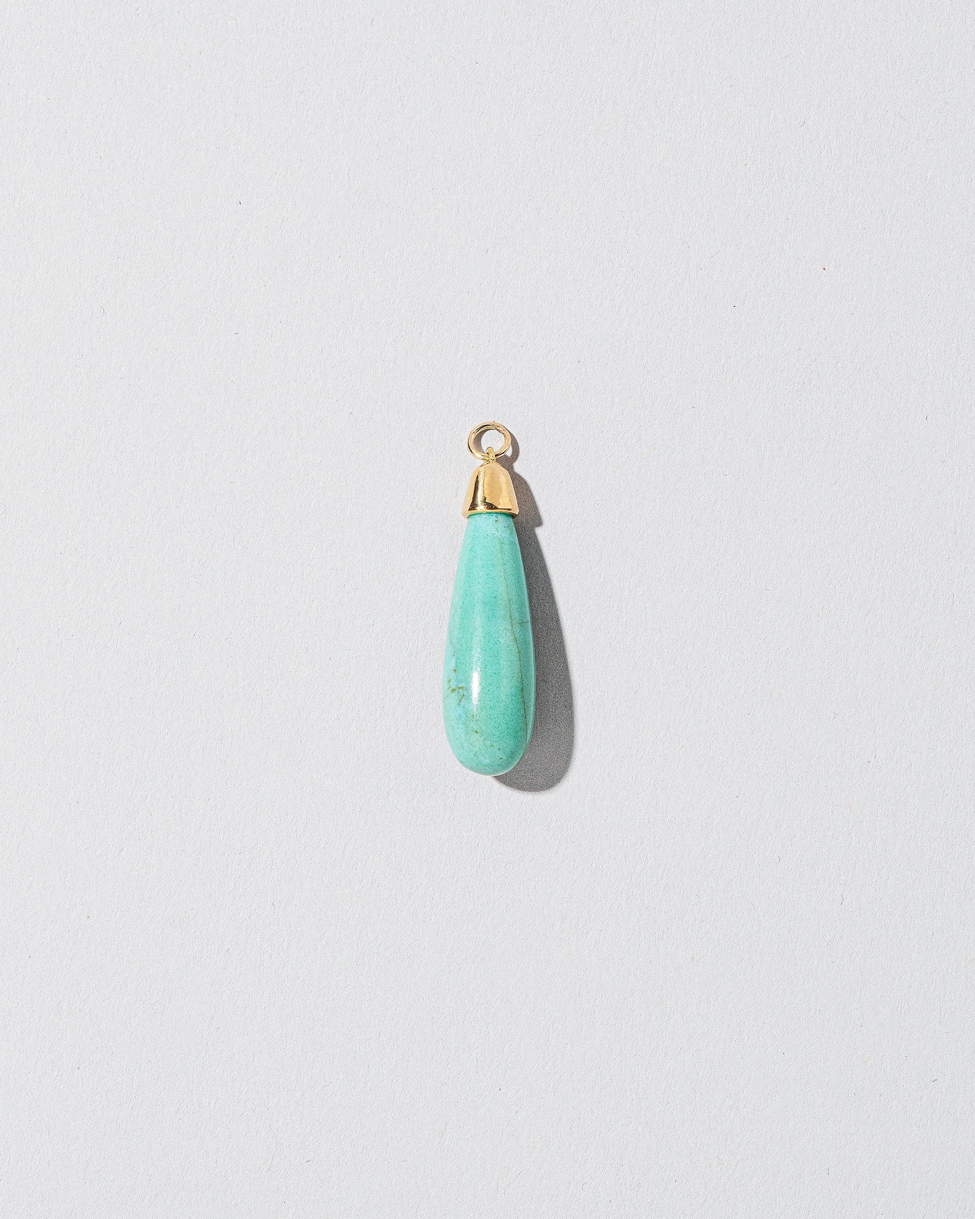 Turquoise Drop Pendant on light color background.