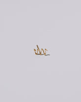 Left Snake Stud Earring Single on light color background.