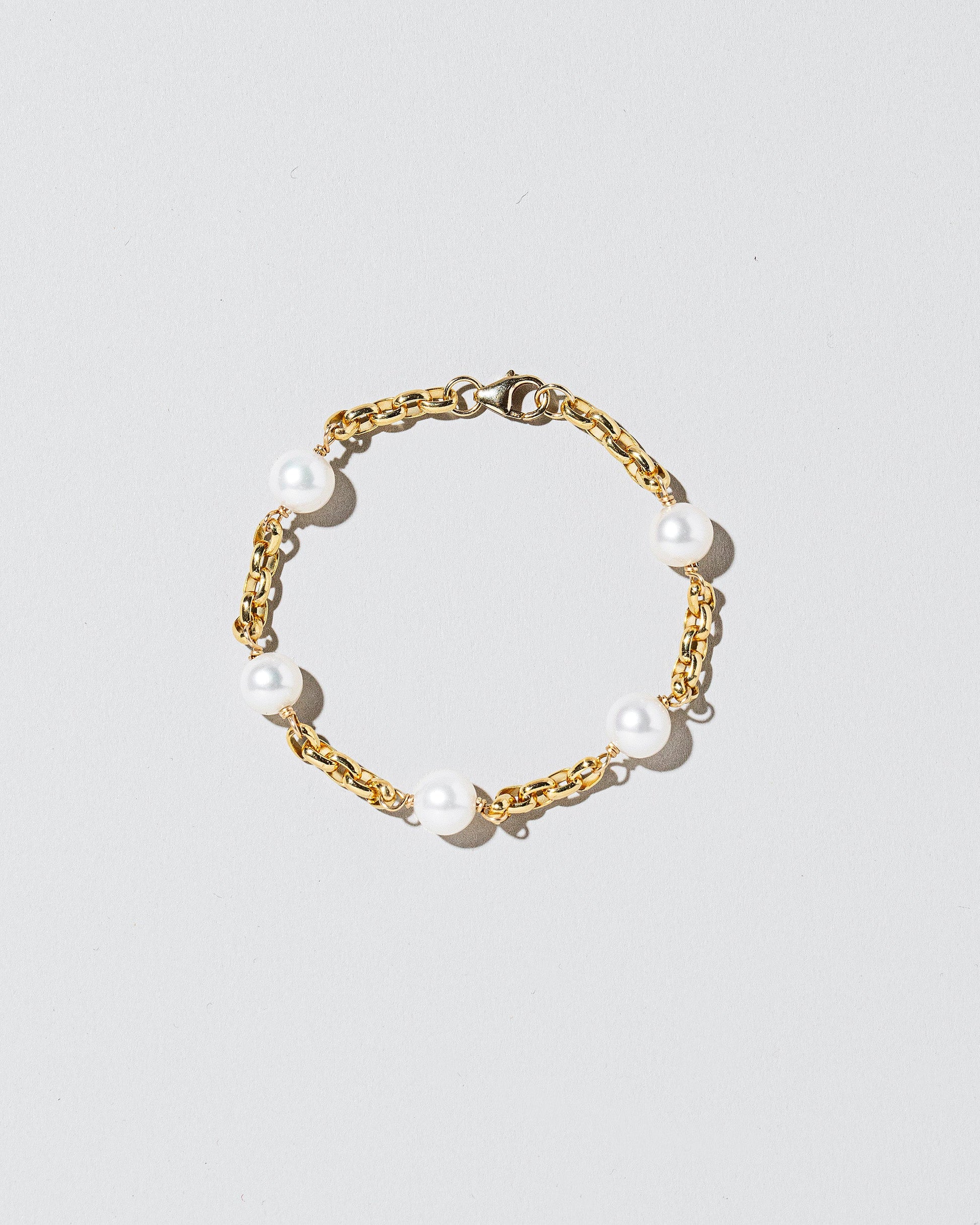 Five Pearl Station Bracelet Short Loop Chain on lightcolor background.