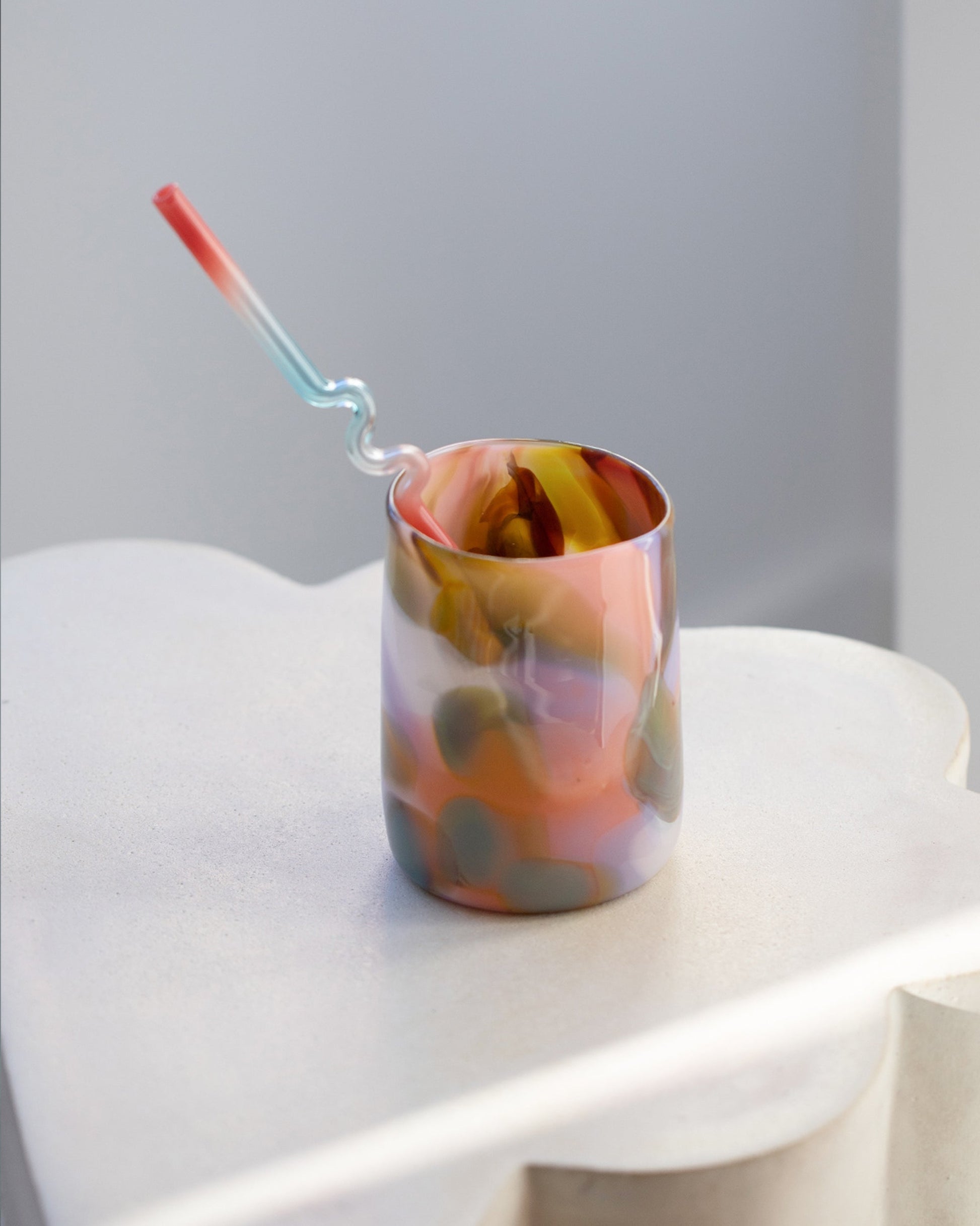 Styled image featuring Misha Kahn Blue and Pink Suck It Up Glass Straw and Balefire Flamingo Epiphany Cup.