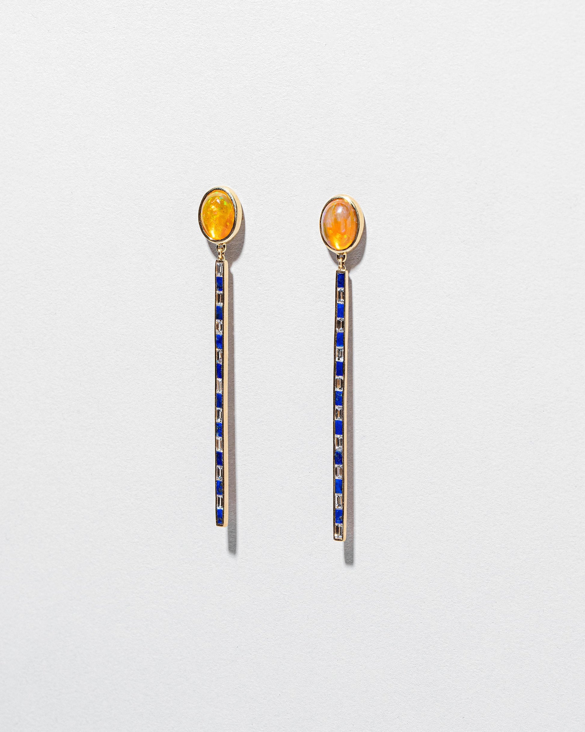 Ethiopian Opal Transformation Earrings on light color background.