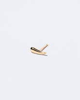 Gold Solid Left Facing One & Others Stud Earring Single on light color background.