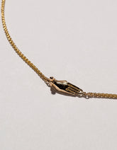 Manifestation Necklace on light color background.