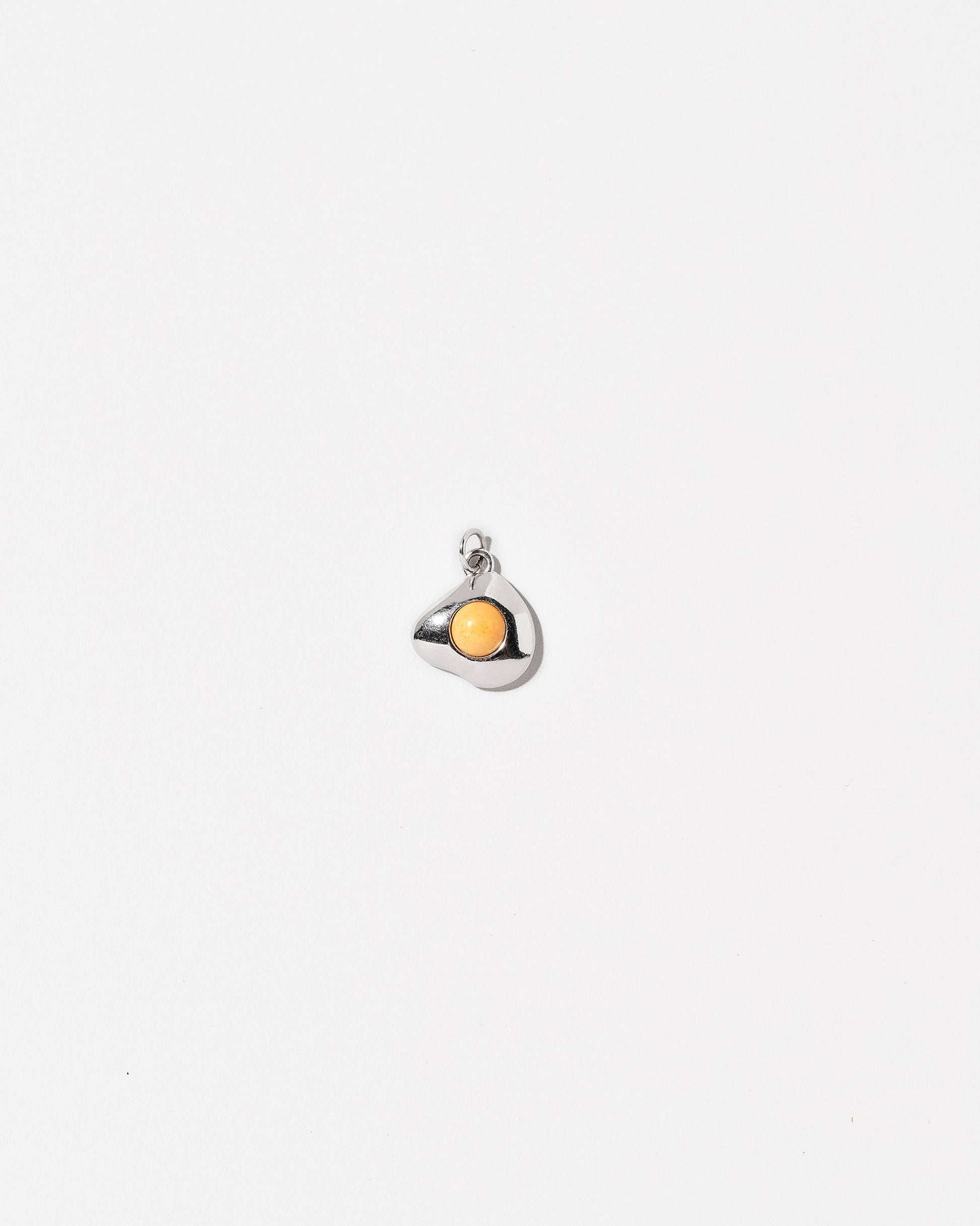 Sunny Side Up Egg Charm Nine on light colored background.