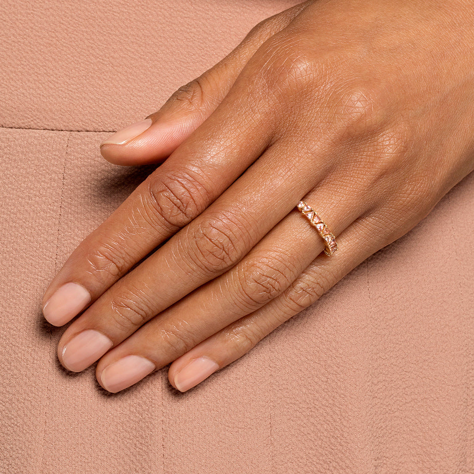 product_details::Peach Sapphire Eleven Trillion Ring on model.