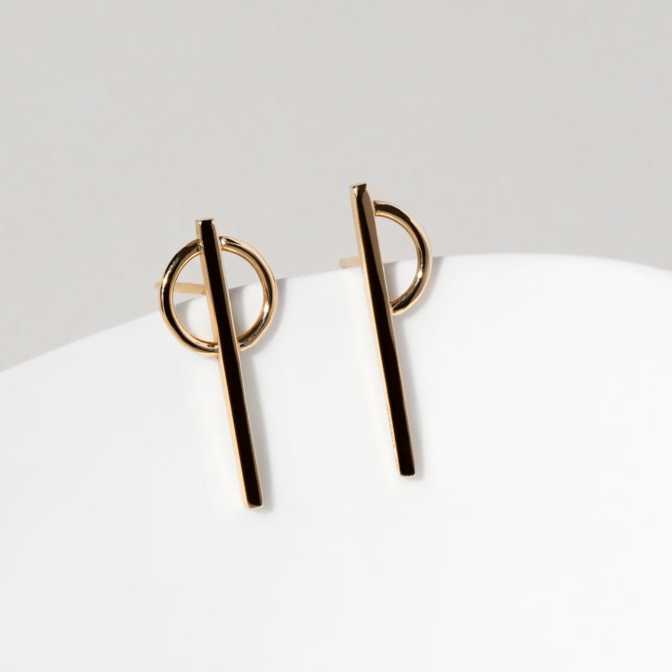 product_details:: Stilt Dance Stud Earrings on light color background.