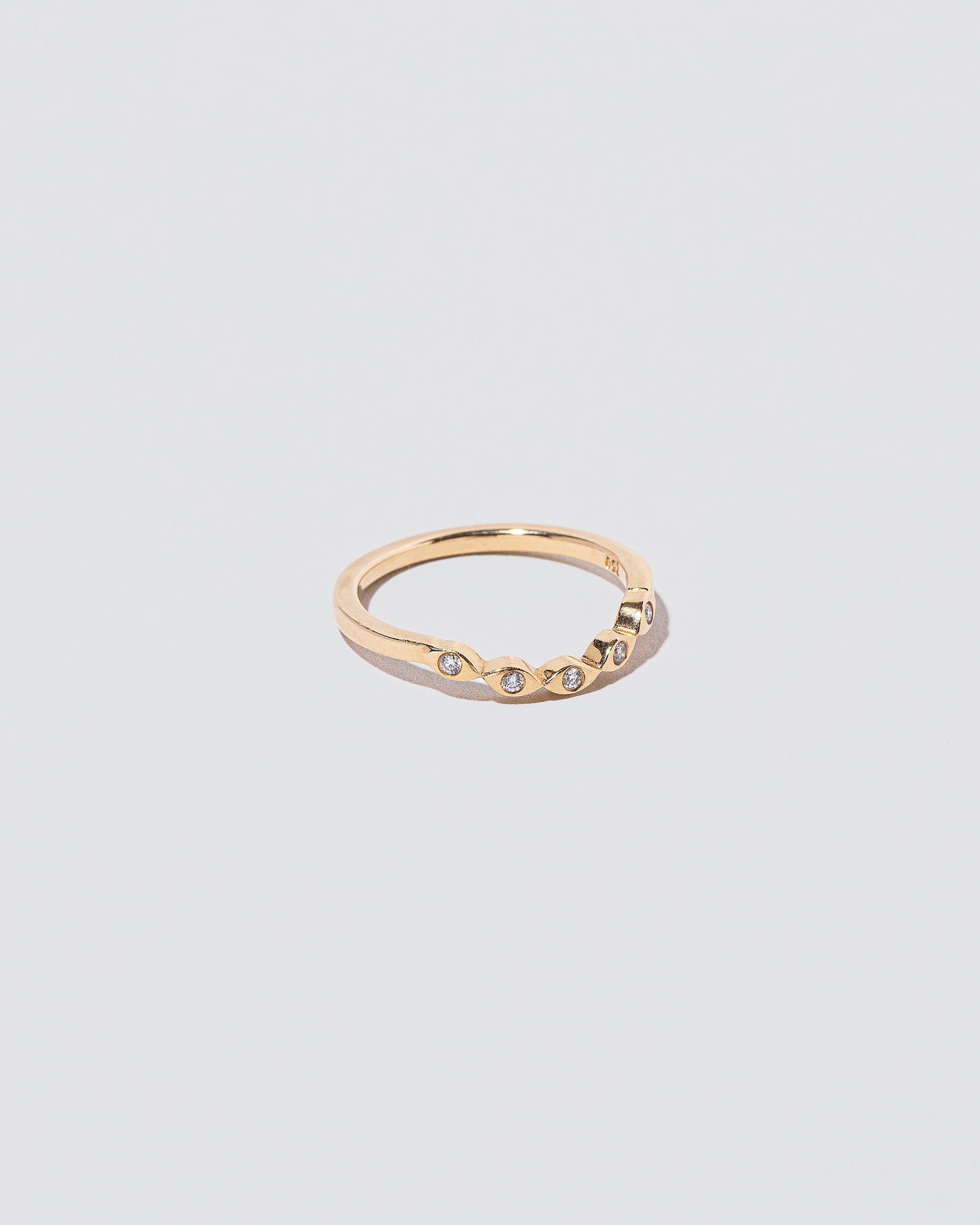 View from the side of the Gold Seeing Eye Band on light color background.