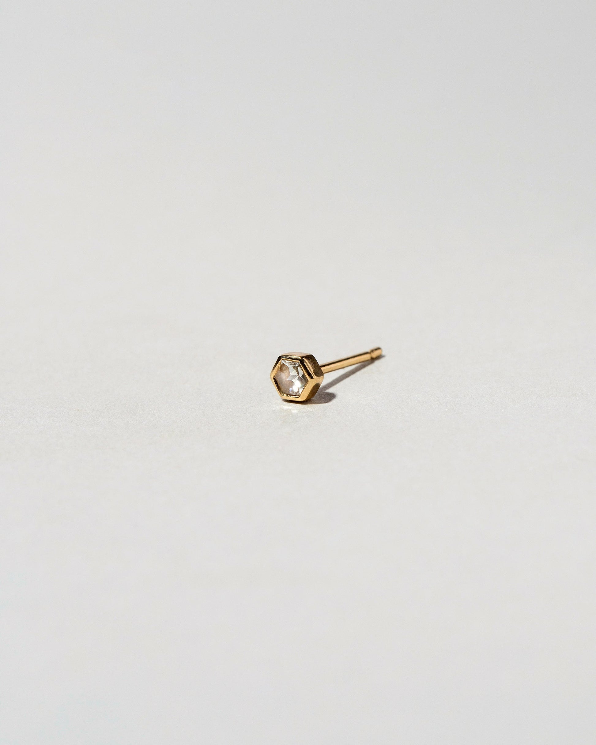 Diamond Hexagon Stud Earring Single on light color background.