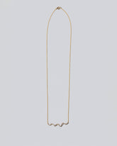 White Diamond Ripple Wave Necklace on light color background.