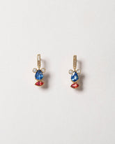 Sapphire & Diamond Creature Earrings on light color background.