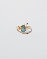Saturnalia Ring on light color background.