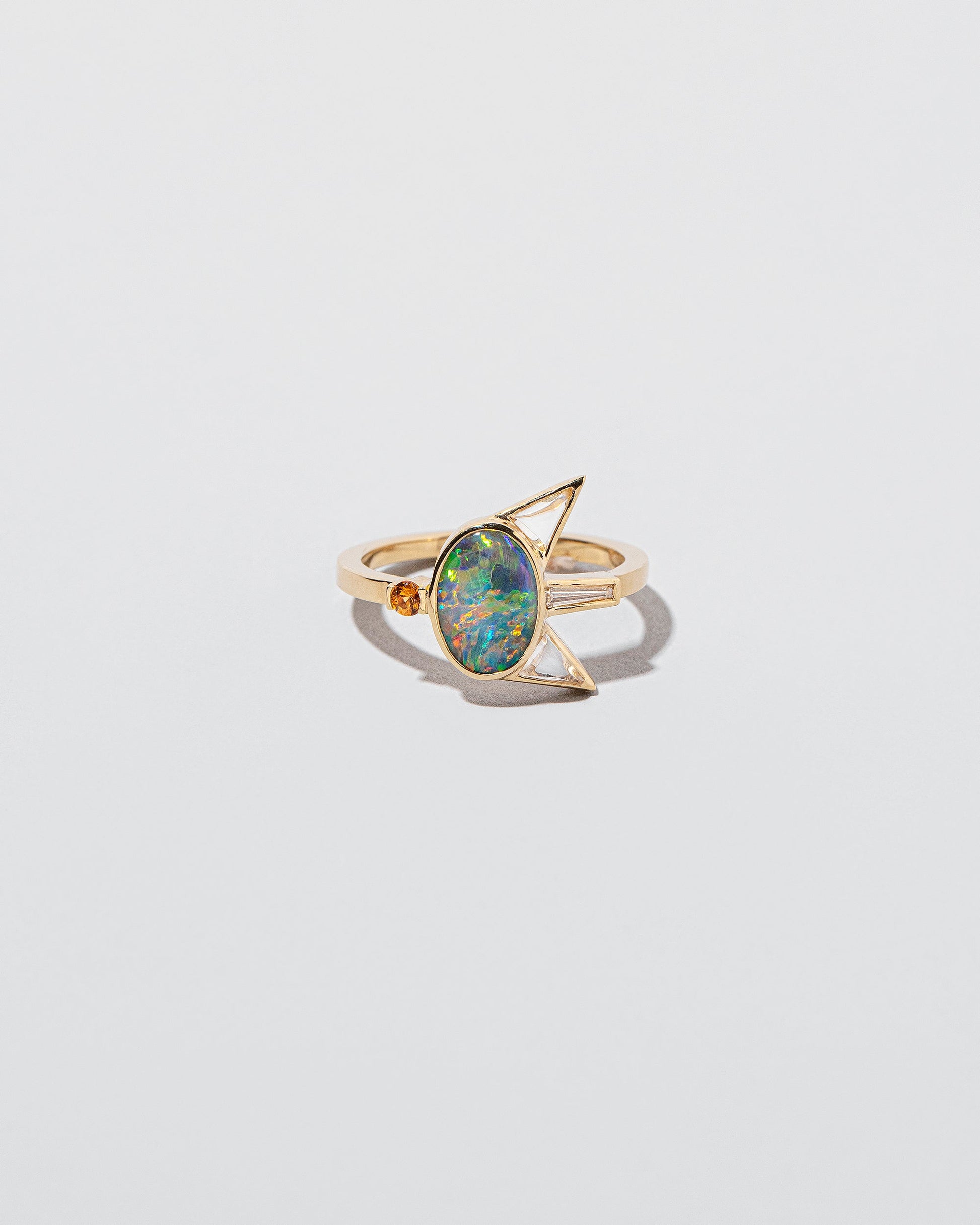Saturnalia Ring on light color background.
