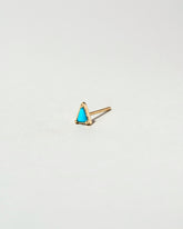 Gold Turquoise Triangle Stud Earring Single on light color background.