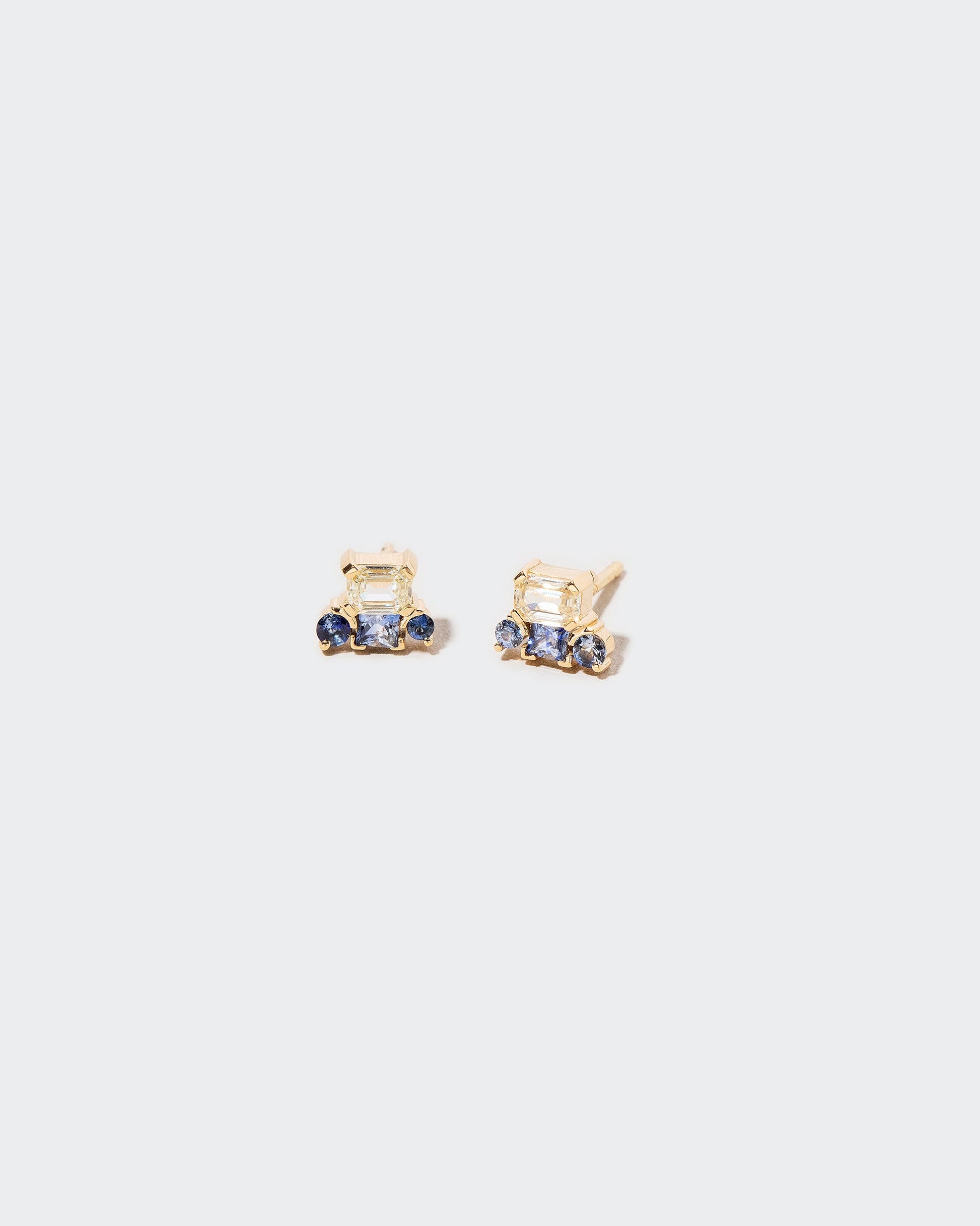 Linear Stud Earrings on light color background.