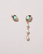 Turquoise Transformation Earrings on light color background.