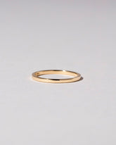 Gold 1.5mm Square Wire Band on light color background.