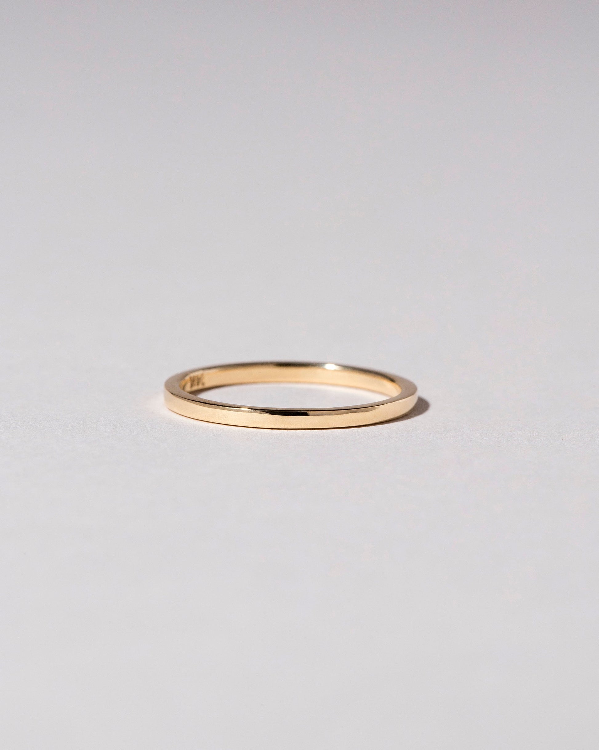 Gold 1.5mm Square Wire Band on light color background.