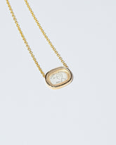 Arrow Intaglio Necklace on light color background.