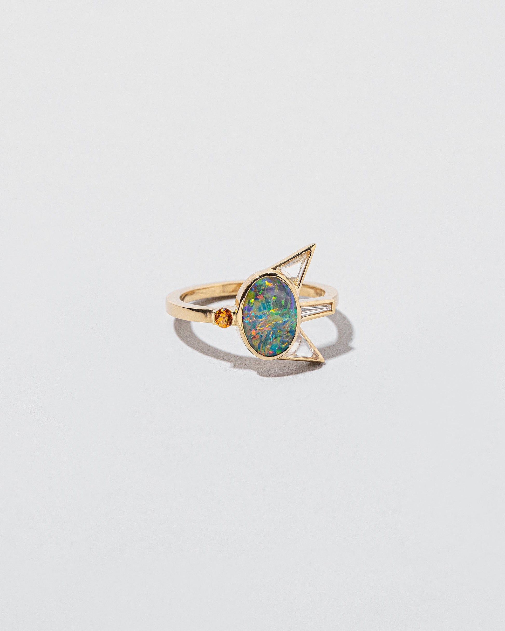 Saturnalia Ring on light color background.