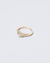 View from the side of the Grand White Diamond Barragán Ring on light color background.