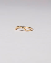 View from the side of the Gold Five Stone White Diamond Mini Curve Band on light color background.