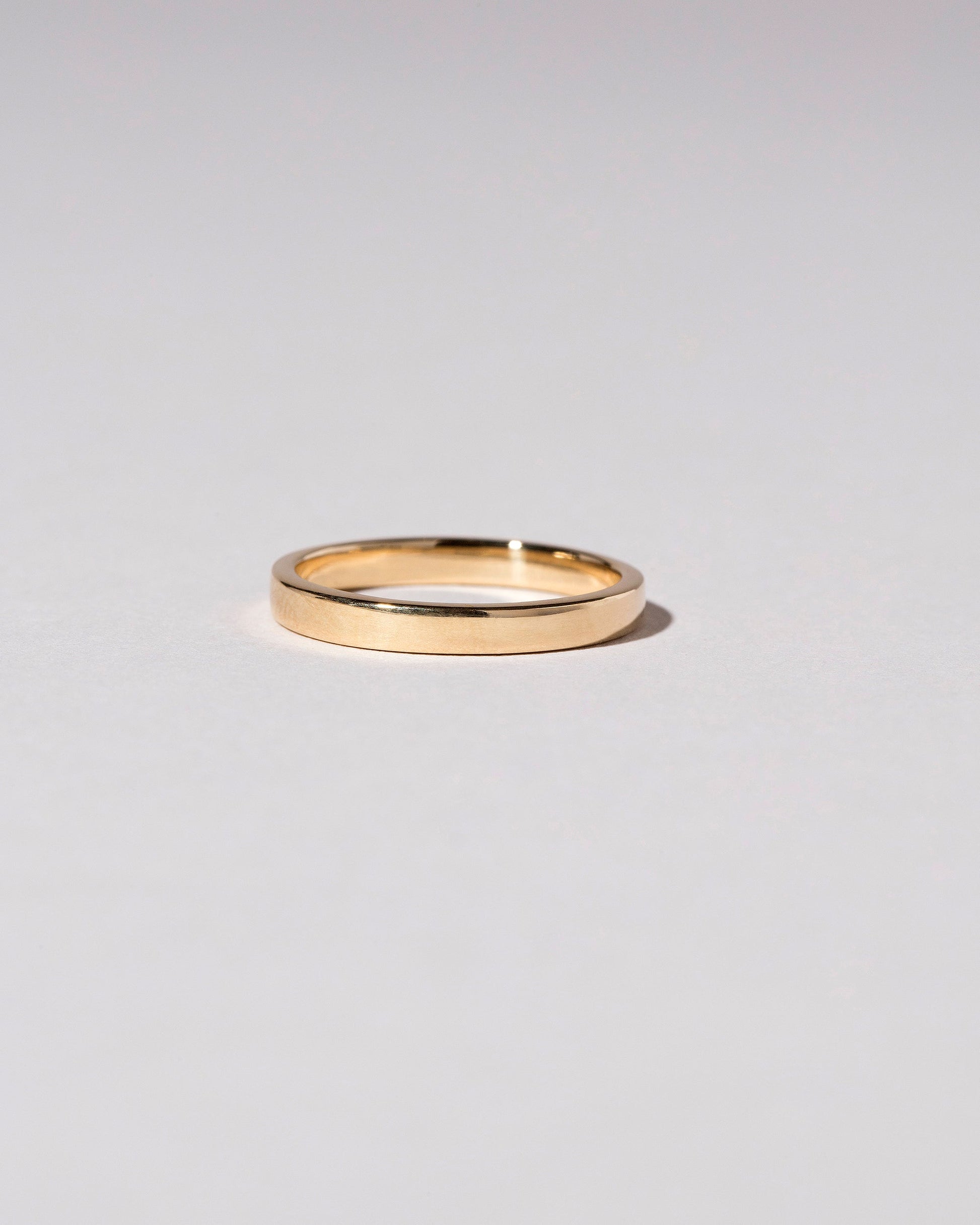 Gold 2.5mm Square Wire Band on light color background.