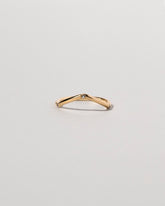 Gold Three Stone Blue Sapphire Low Peak Band on light color background.