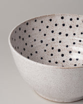 Detail view of Recreation Center Dot Serving Bowl on light color background.