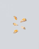 Swiss Cheese Charms on light color background.