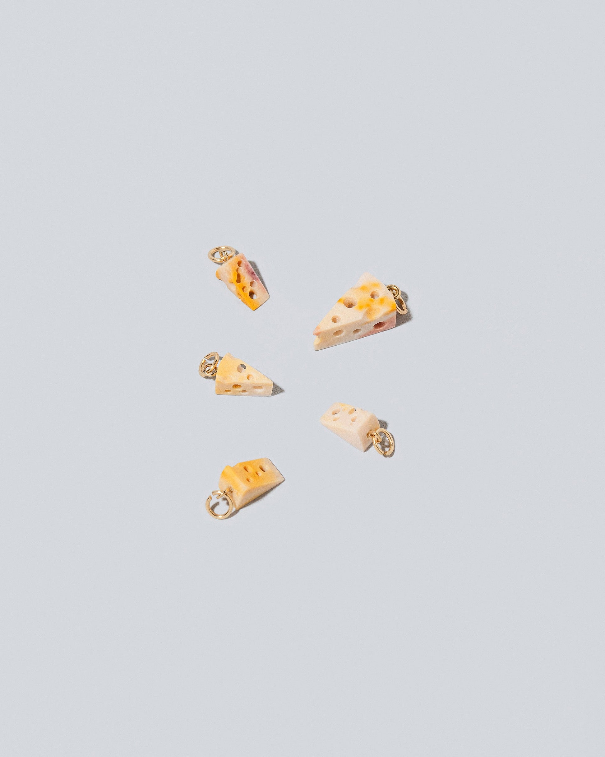 Swiss Cheese Charms on light color background.