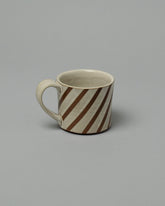 Jeremy Ayers Brown Diagonal Striped Mug on light color background.