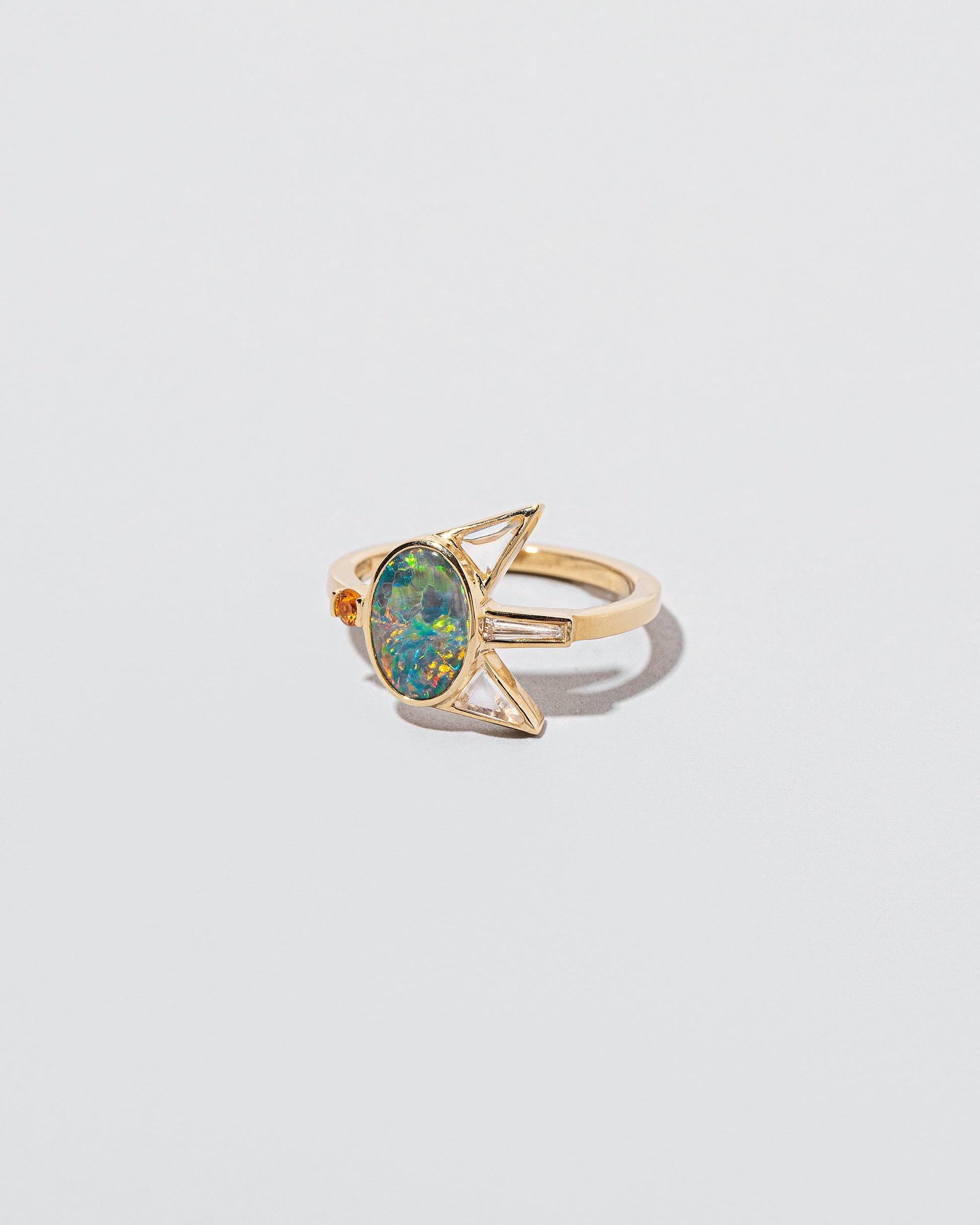 Saturnalia Ring on light color background.