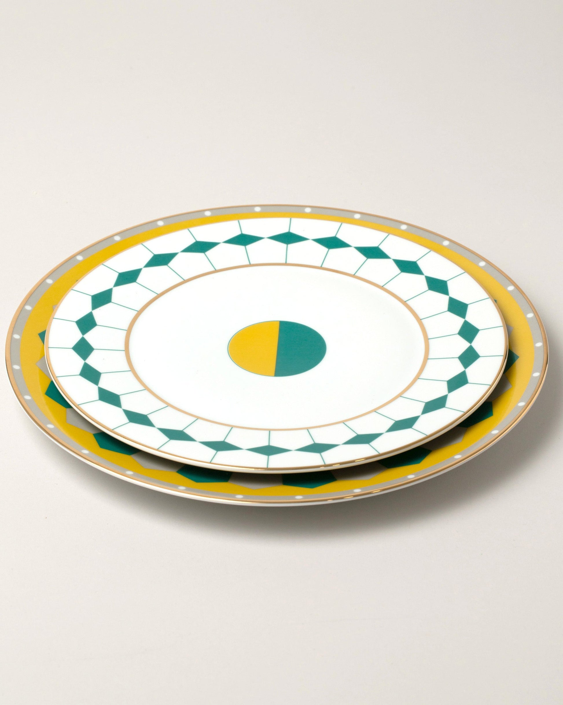 Group of Reflections Copenhagen Ponta Dessert Plate and Lagos Dinner Plate on light color background.