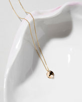 Pearl Cup Necklace on light color background.