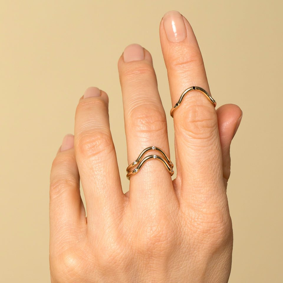 product_details::Gold Three Stone Curve Bands on model.