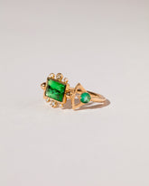 Emerald Lotus Ring on light color background.
