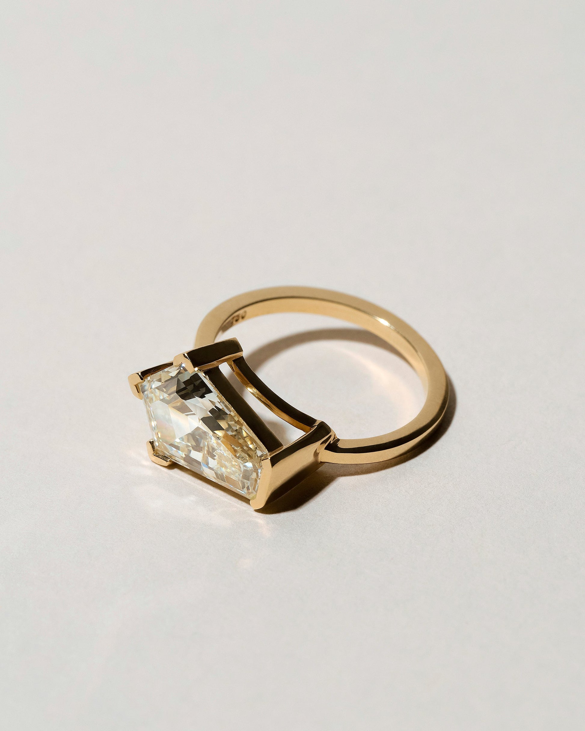 View from the side of the Modified Step Cut Diamond Ring on light color background.