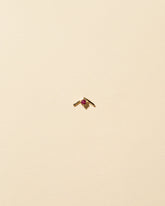 Gold Ruby Sun Catcher Stud Earring Single on light color background.