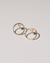 Coil Stud Earrings on light color background.