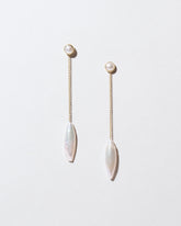 Navette Pearl Drop Earrings on light color background.