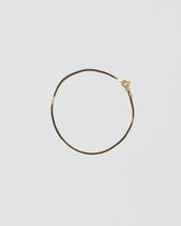 Liquid Chain Bracelet on light color background.