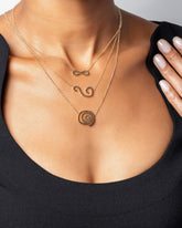 Black Diamond Infinity Necklace, Full Black Diamond Spiral Necklace and Black Diamond Symbol of Change Necklace on model.