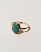 View from the side of the Australian Black Opal Ring on light color background.