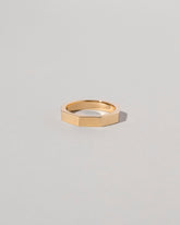 Gold 4mm Segmented Half Hoop Band on light color background.