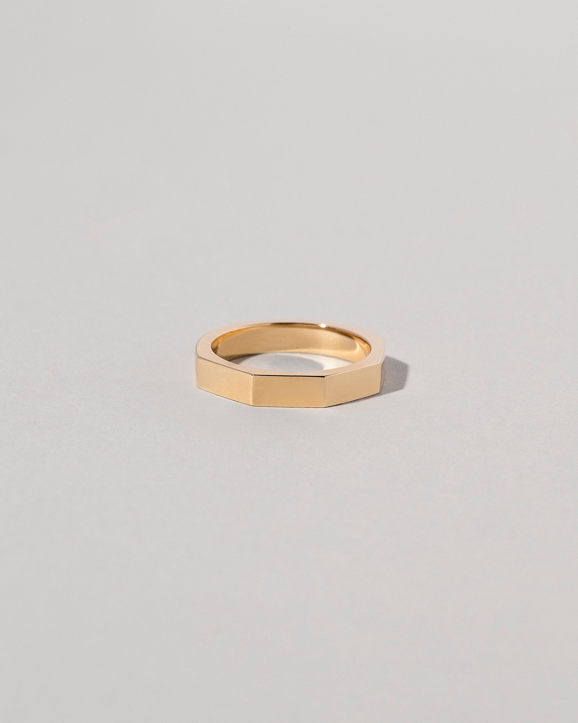 Gold 4mm Segmented Half Hoop Band on light color background.