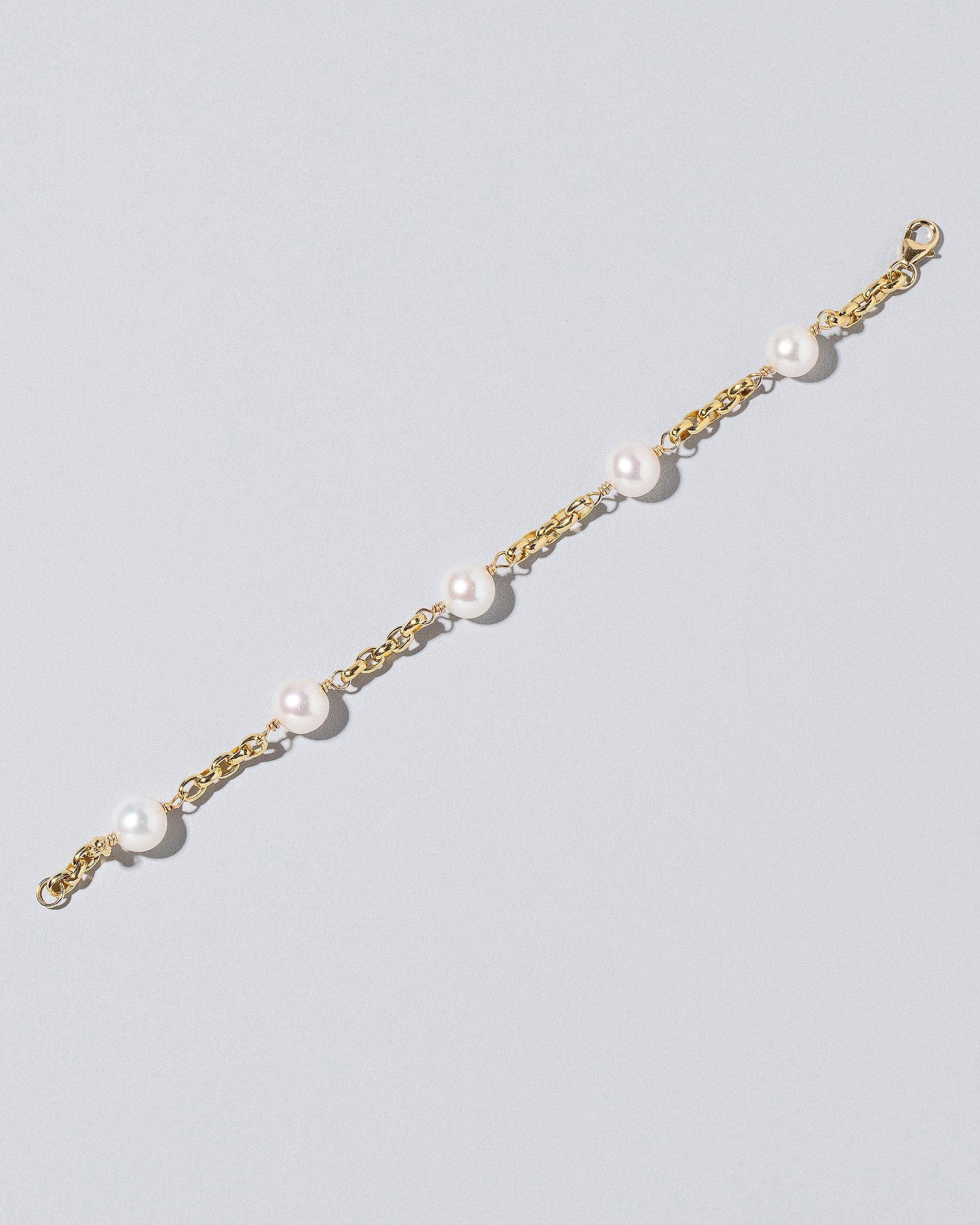 Five Pearl Station Bracelet Short Loop Chain on lightcolor background.